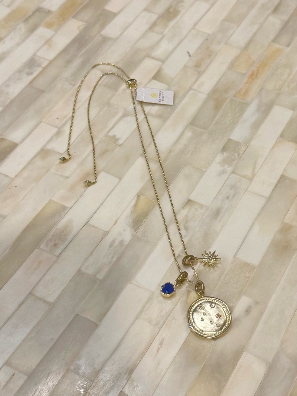 NWT Kendra Scott Libra Necklace - Gold Tone with Blue Stone and Sunburst Charm
